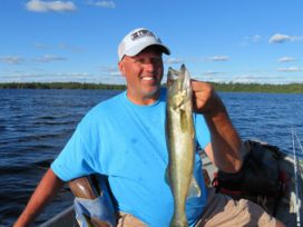 Guy in Blue T-shirt holding Fish